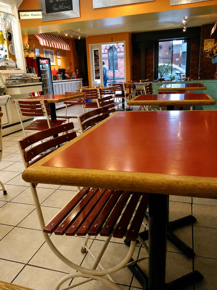 Sunlight, café tables and chairs inside Broughton Street Deli
