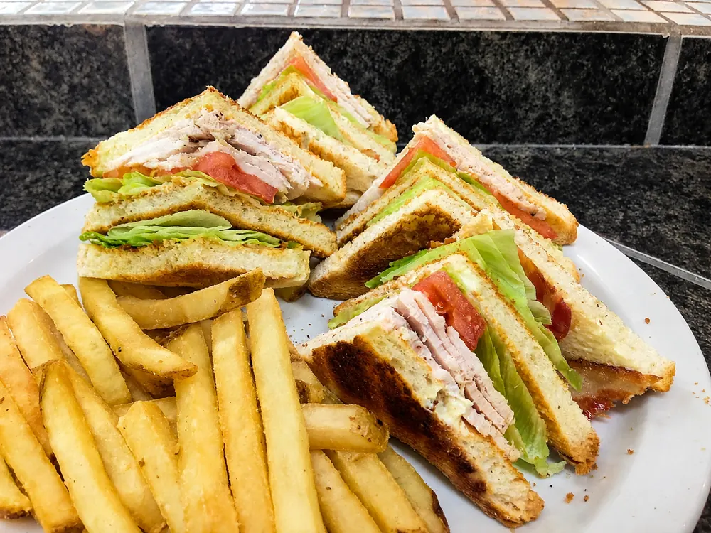 Clubhouse sandwich with fries at the deli